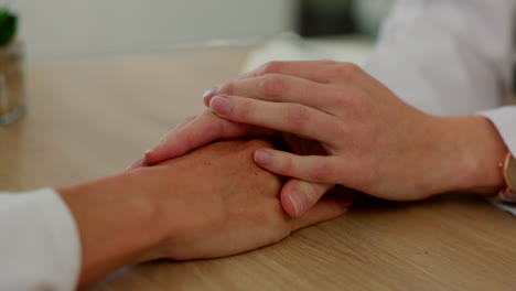 doctor holding hands with patient in empathy