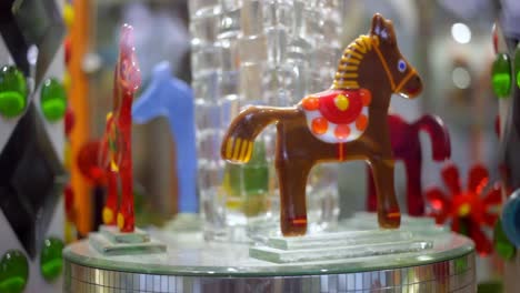 glass horses turning around. close up of glass souvenir present