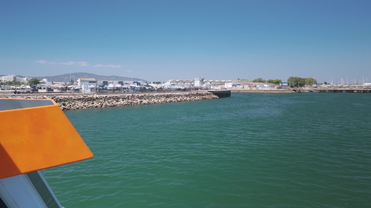 Crossing by ferry in Olhão Portugal with waterfront and boatyard in background