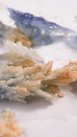 shiny bath sea salt crystals scattered on white surface extreme closeup. minerals grown at chemistry lesson. healthcare and education experiments
