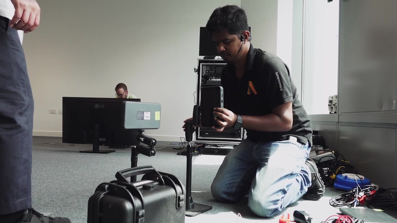 Software engineers setting up monitors for an event