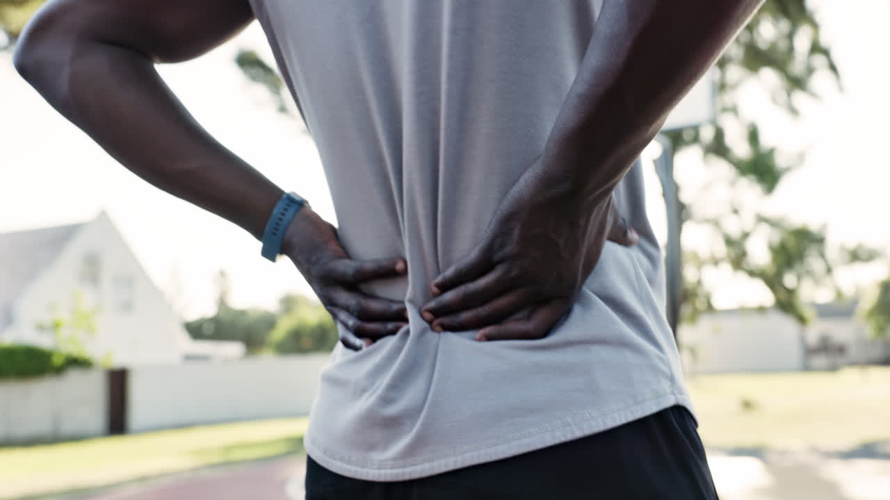 Man experiencing back pain during workout