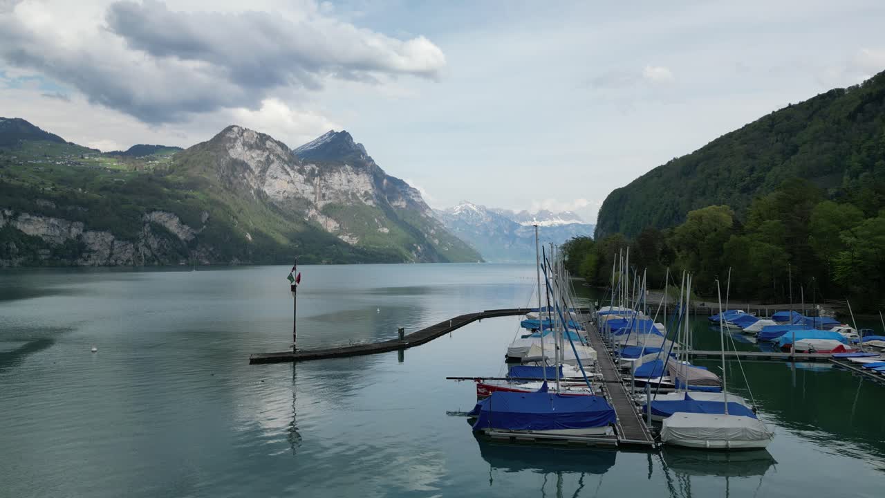 Boats on the lake in front of a small village in G&auml;si Betlis, Walensee Glarus, Weesen Walenstadt, Switzerland