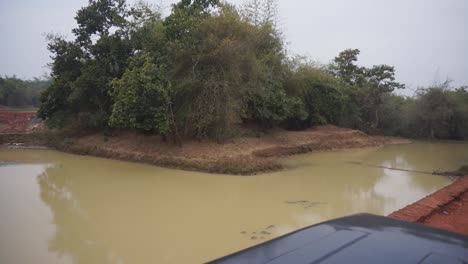 Driving-a-jeep-down-a-red-dirt-road-on-safari