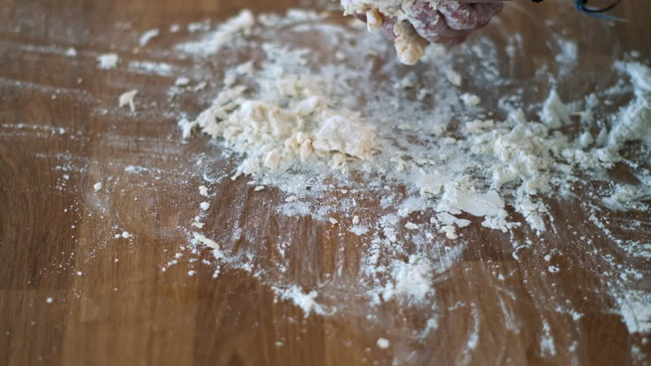 Hands of Baking: Senior Baker's Slow-Mo Closeup - Applying Flour and Kneading Traditional Bread