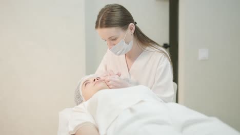 cosmetologist performing facial injection procedure