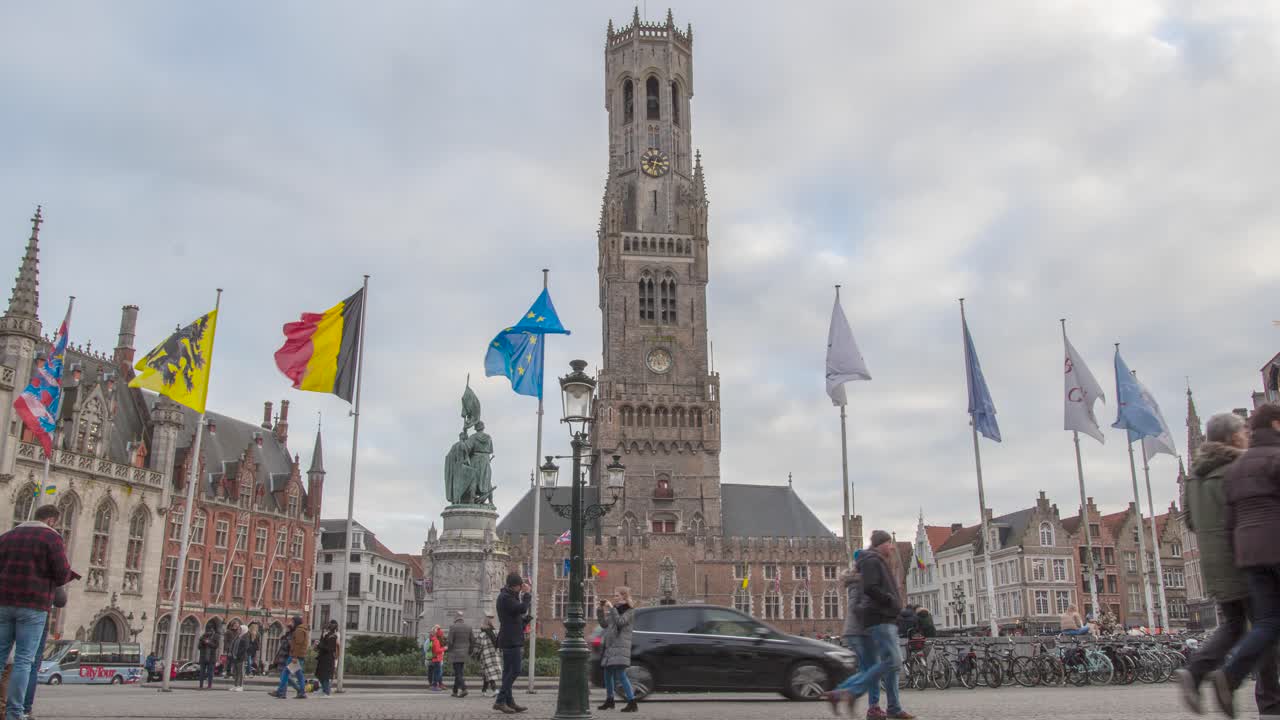 Time lapse of the view of the belfry in Bruges. The market place in Bruges center. outlook on the medieval bell tower. World heritage. People on the square in the ancient town of Bruges, Belgium.
