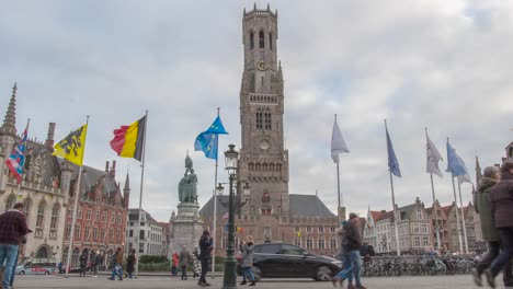 time lapse of the view of the belfry in bruges. the market place in bruges center. outlook on the medieval bell tower. world heritage. people on the square in the ancient town of bruges, belgium.