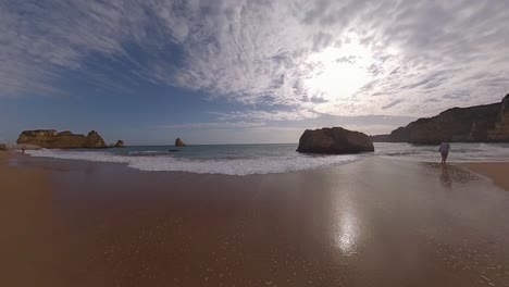 seascape paradise: beach, water, rocks, cliffs, and blue sky with clouds