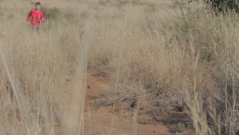 man running uphill on a trail during winter time