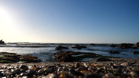 low angle wide shot of peaceful atlantic ocean water on a sunny blue sky day in bantry bay, south africa