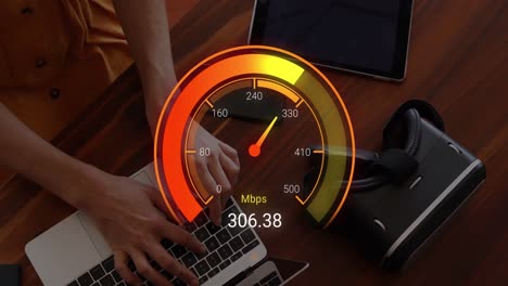 animation of orange speedometer over hands of caucasian woman using laptop