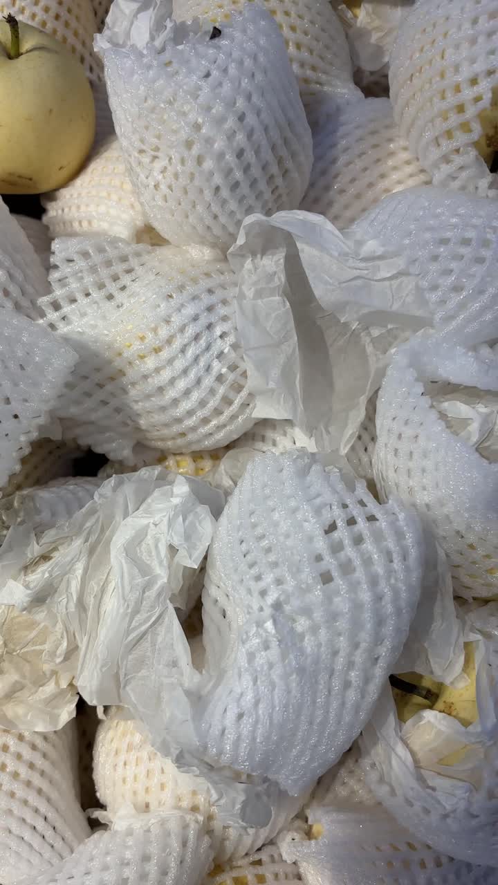 Fresh Yellow Pears Wrapped in Protective Foam Netting
