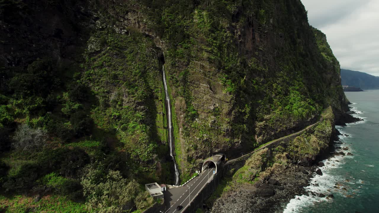 Drone Footage of Large Waterfall Next to the Road, Car Driving, Steep Mountain, Ocean, Madeira 4k