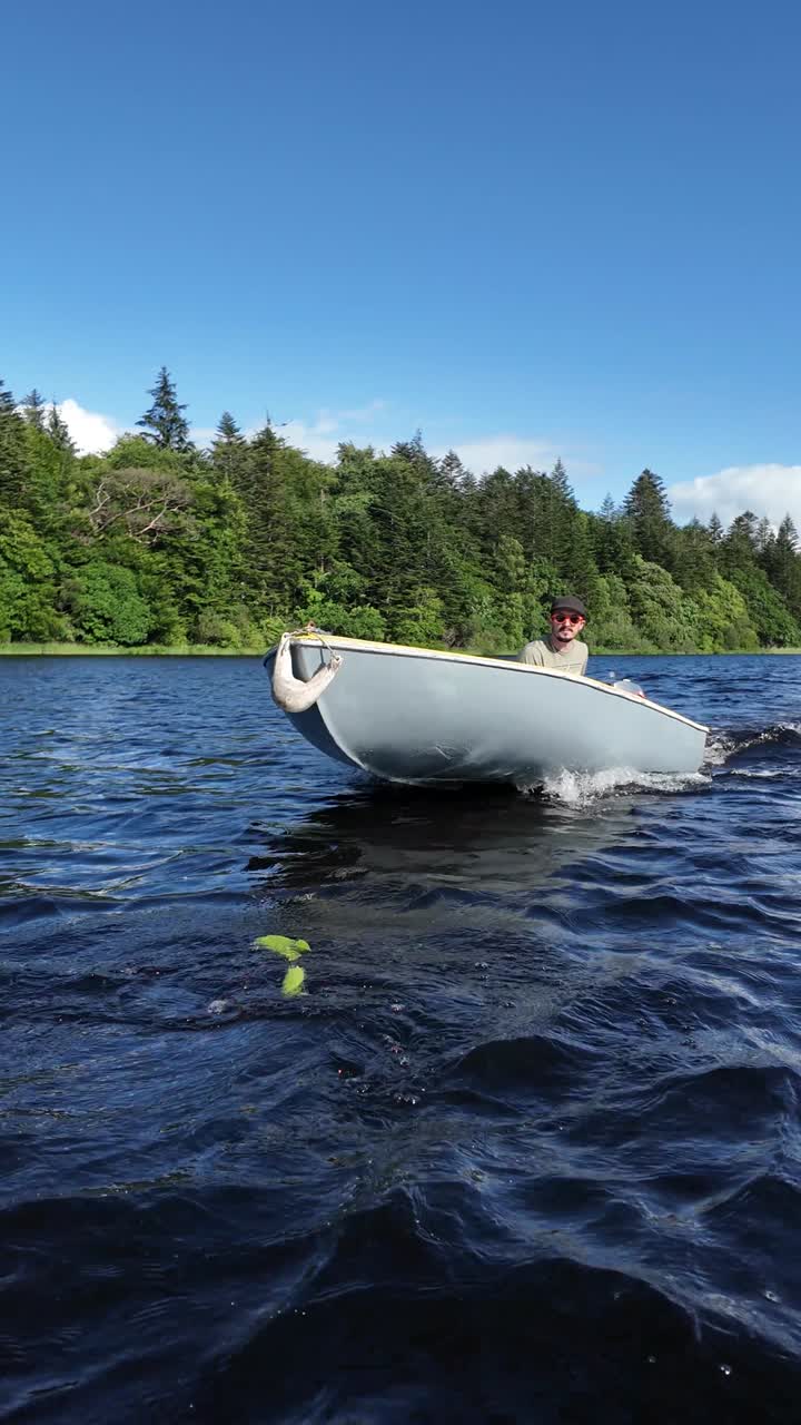 Man Cruising on a Small Dinghy on a Peaceful Forest Lake