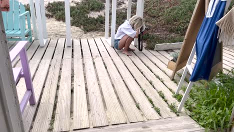 young woman photographer taking pictures and photos with camera outdoors