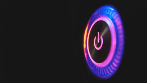 un bucle de video macro de 4k de un botón de encendido de la computadora en la unidad del sistema sobre un fondo negro.