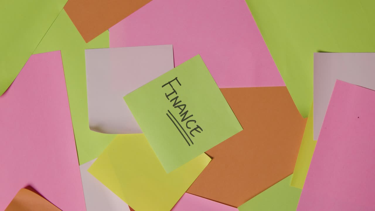 Business Concept Of Revolving Sticky Notes With Finance Written On Top Note