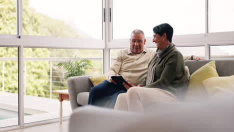 Senior-couple,-relax-and-happy-on-tablet-in-home