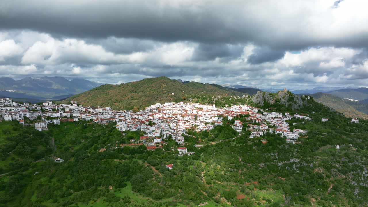 Beautiful cinematic drone view of Gaucín City in the mountains of Spain, Europe. Cloud shadows are covering mountains around. High quality 4K prores footage.