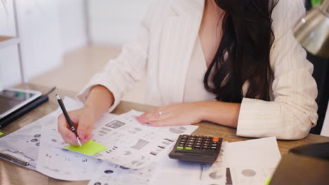 confident, focused woman uses a calculator and works on the financial condition of the company