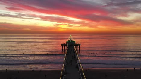 manhattan beach pier against dramatic sunset horizon in california, united states