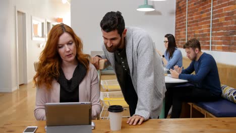 business executives discussing over digital tablet