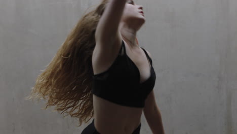 dancing-woman-talented-young-caucasian-street-dancer-performing-contemporary-moves-enjoying-modern-dance-expression-practicing-in-grungy-warehouse-close-up