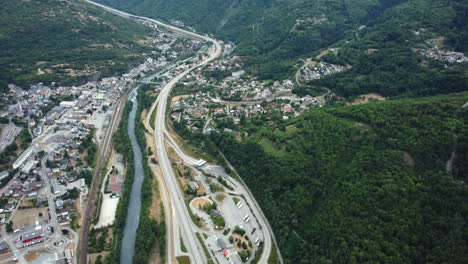 aerial view of a valley with a river and highway
