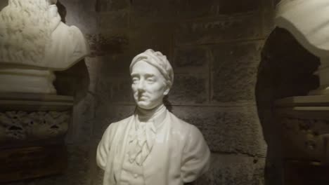 panning shot of multiple famous sculptures inside the wallace monument in stirling