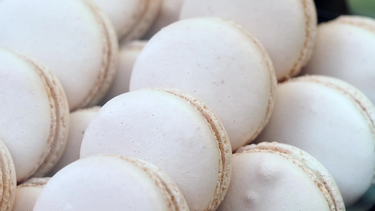 Close-up of Delicious White Macarons in a Bakery Display