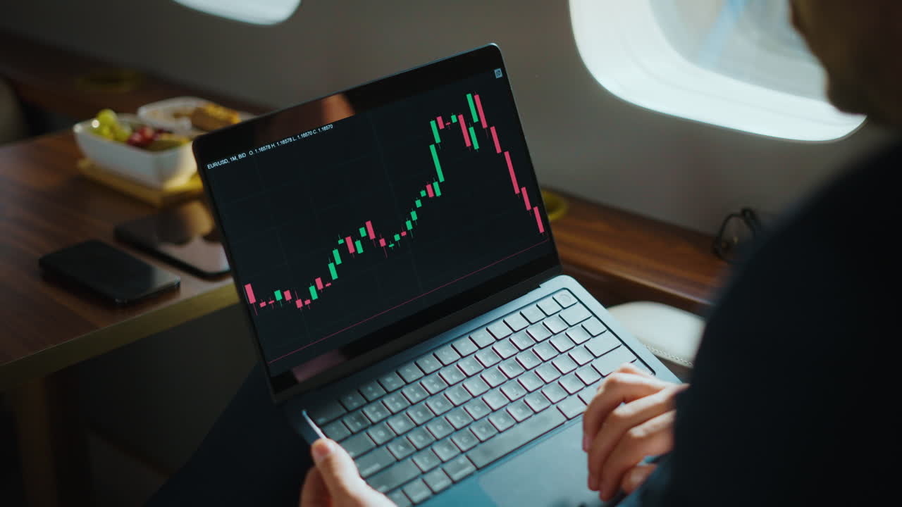 Businessman Analyzing Stock Market on Private Jet