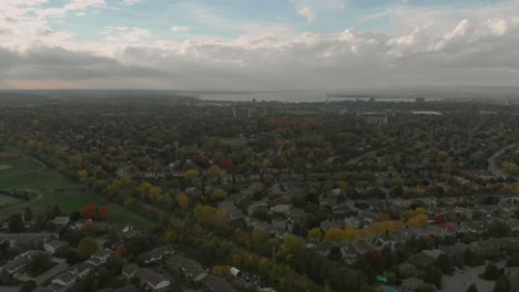 Aerial-footage-facing-towards-downtown-Ottawa-with-views-of-huge-city-buildings-in-the-distance-as-well-as-the-Ottawa-river-and-some-sub-divisions-and-a-train-track-in-the-foreground