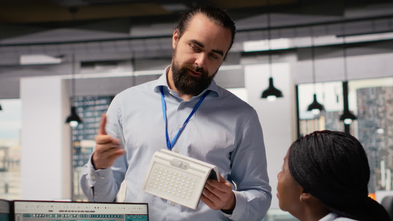 Team Of Technicians Brainstorming Solar Powered Device Design