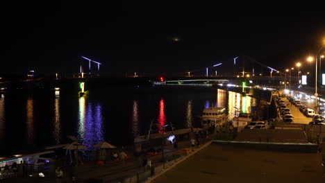 illuminated parkovyi bridge over dnieper river at night