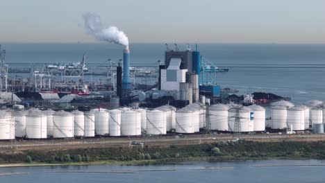 am industrial shipyard in the netherlands with oil storage tanks in the foreground