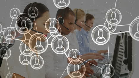 in office, customer service team working at computers with network overlay animation
