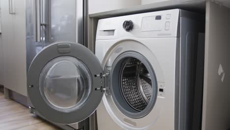 close up of empty washing machine with open door at home, slow motion