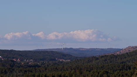 Wind-turbines-timelapse-with-fast-moving-clouds-on-the-background