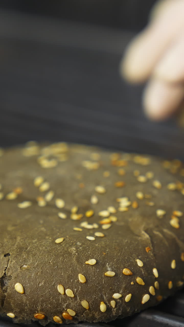 Cooking burger in the kitchen. Professional chef preparing burger at restaurant kitchen. Vertical video