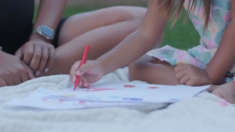 little girl drawing outside