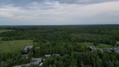 Aerial-View-Over-Village-Surrounded-With-Lush-Green-Vegetation---drone-shot