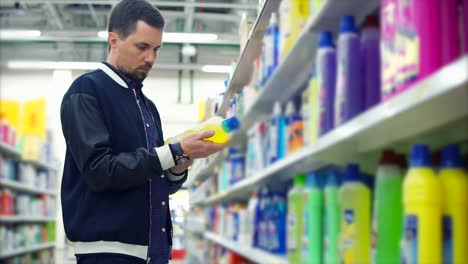 man shopping for cleaning supplies in a supermarket