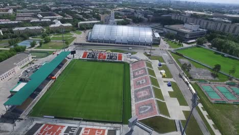 aerial view of a modern sports stadium complex in a city