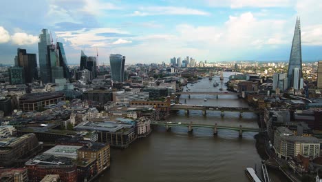 cinematic aerial view of downtown london uk, thames river, skyscrapers and cityscape skyline