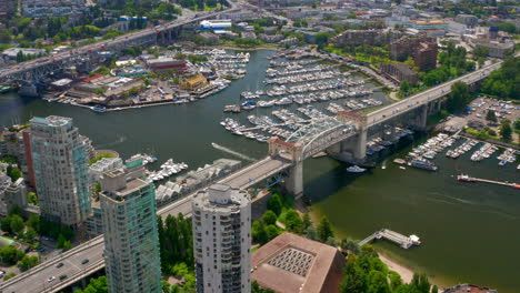 aerial view of burrard street bridge with boats on marina in vancouver, bc, canada