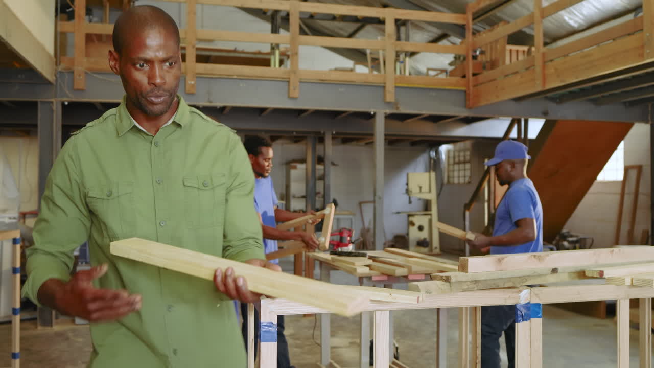 African American team gathering at workbench while instructor guiding measuring and pointing exit