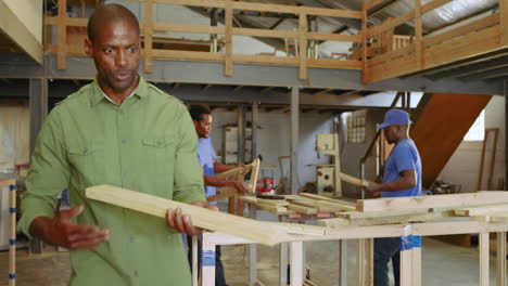african american team gathering at workbench while instructor guiding measuring and pointing exit