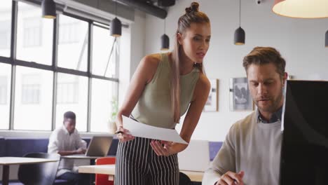 Happy-caucasian-business-people-discussing-work-during-meeting-at-office