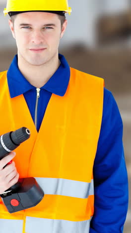 animation of happy labor day text over caucasian man holding drill